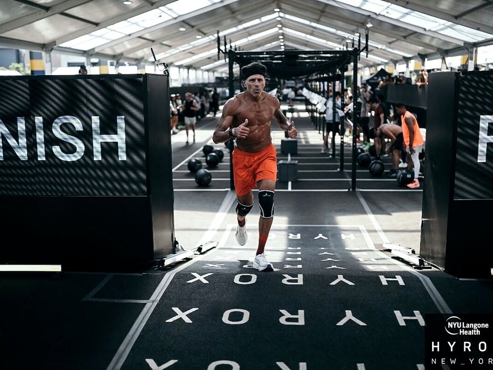 A client running through the HYROX finish gate