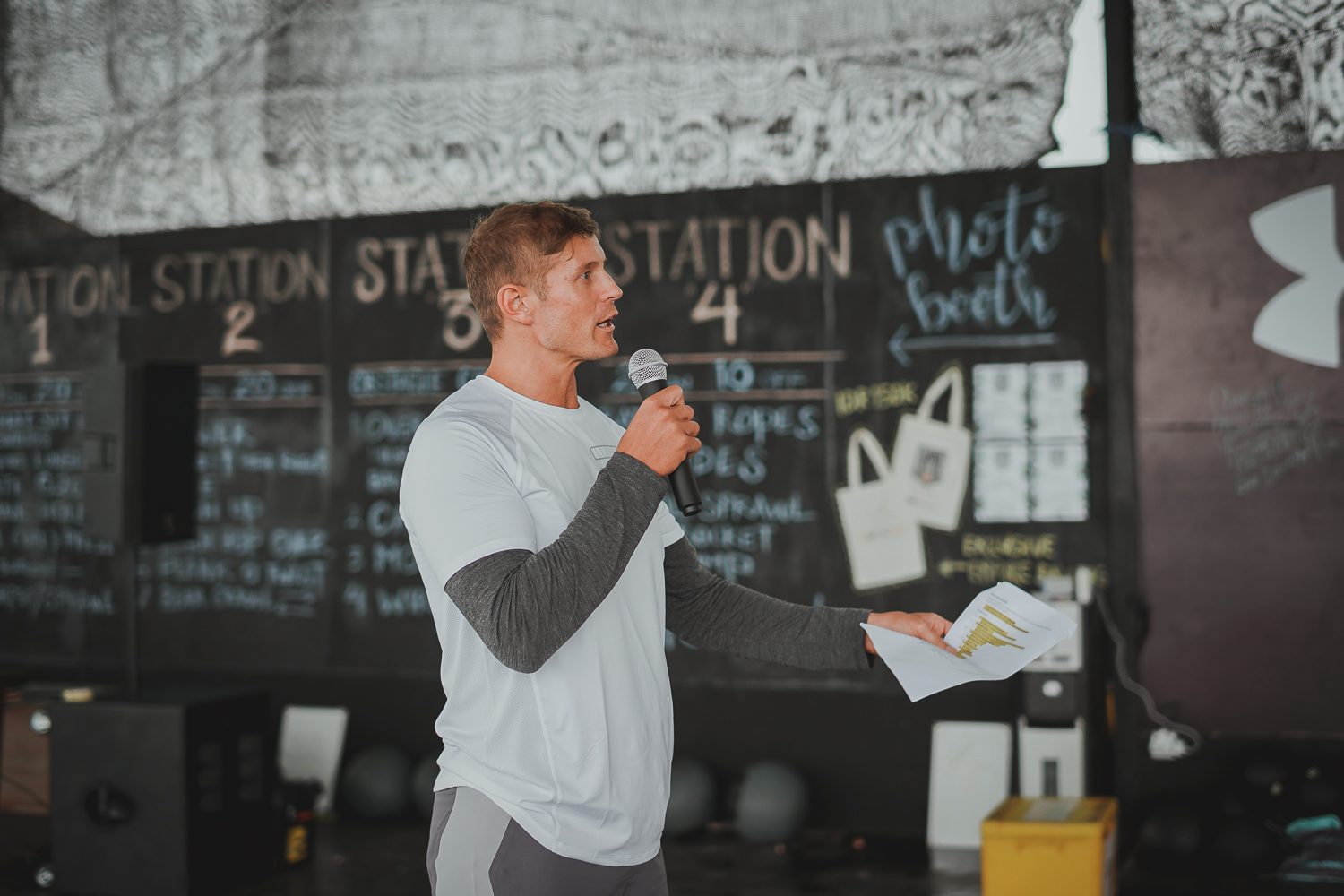 Dai Manuel speaking into a microphone at the gym