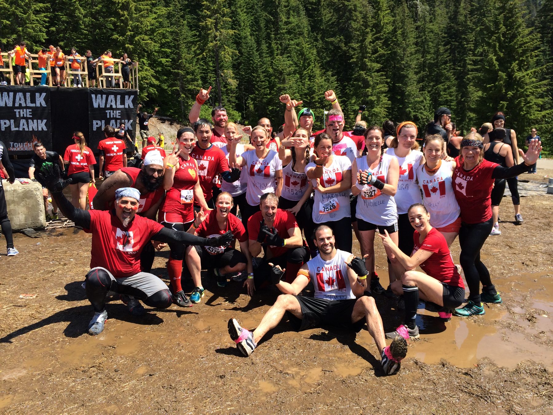 Dai Manuel with a mud covered team after an obstacle race