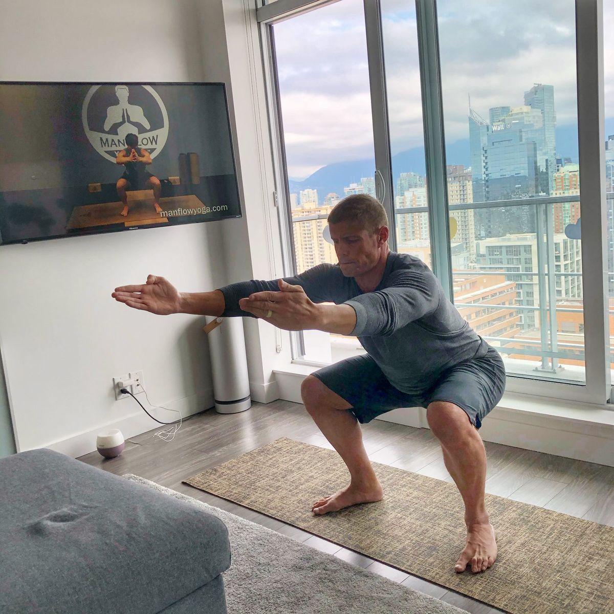 Dai Manuel doing air squats in his living room